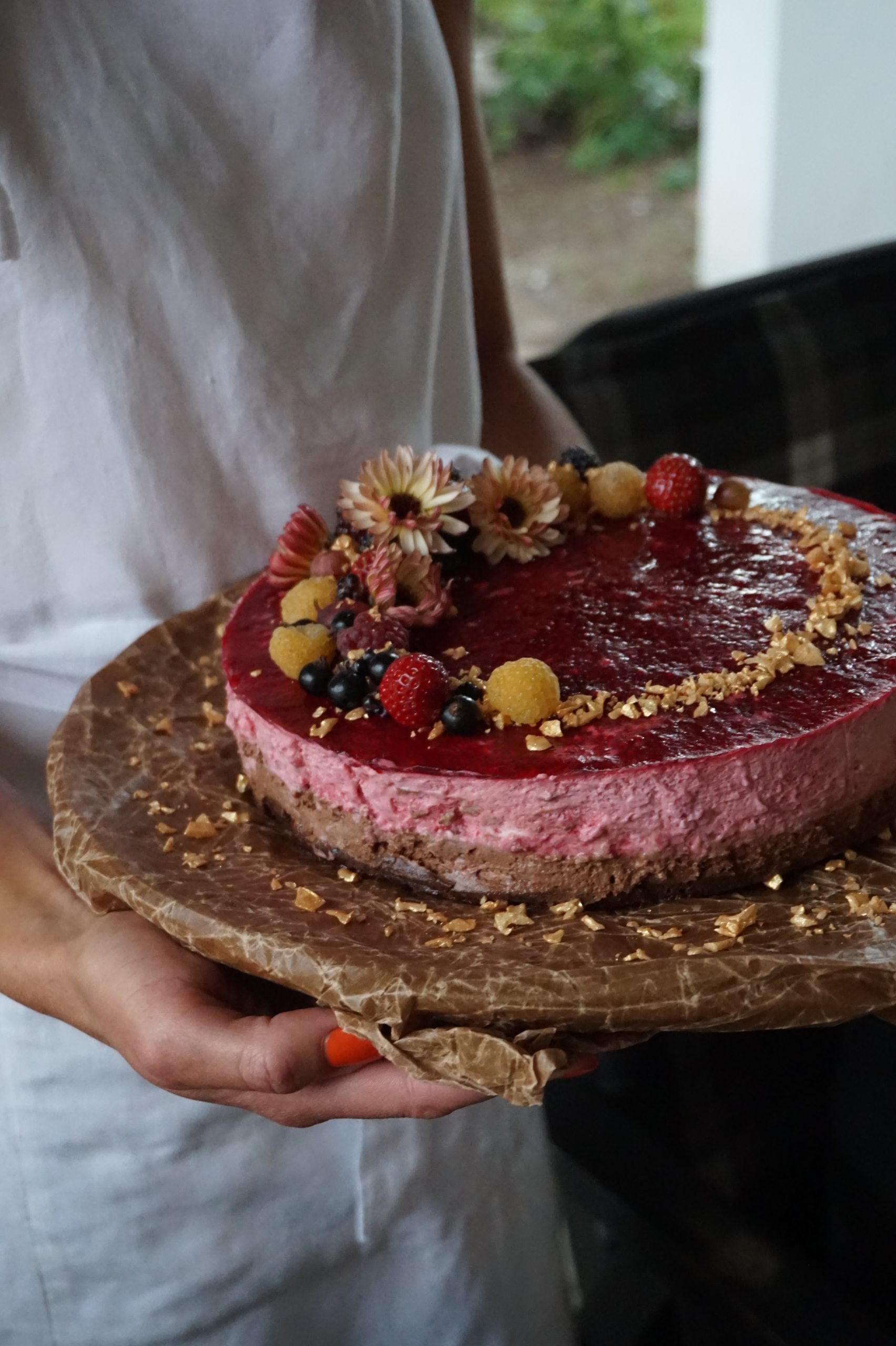 Berry cheesecake on wooden plate