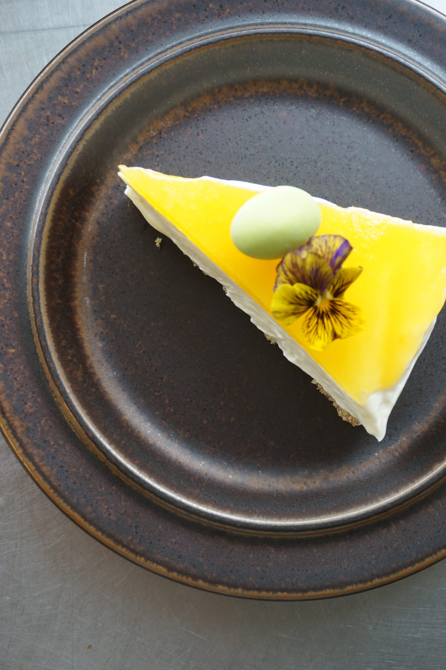 Lemon cake slice on dark plate