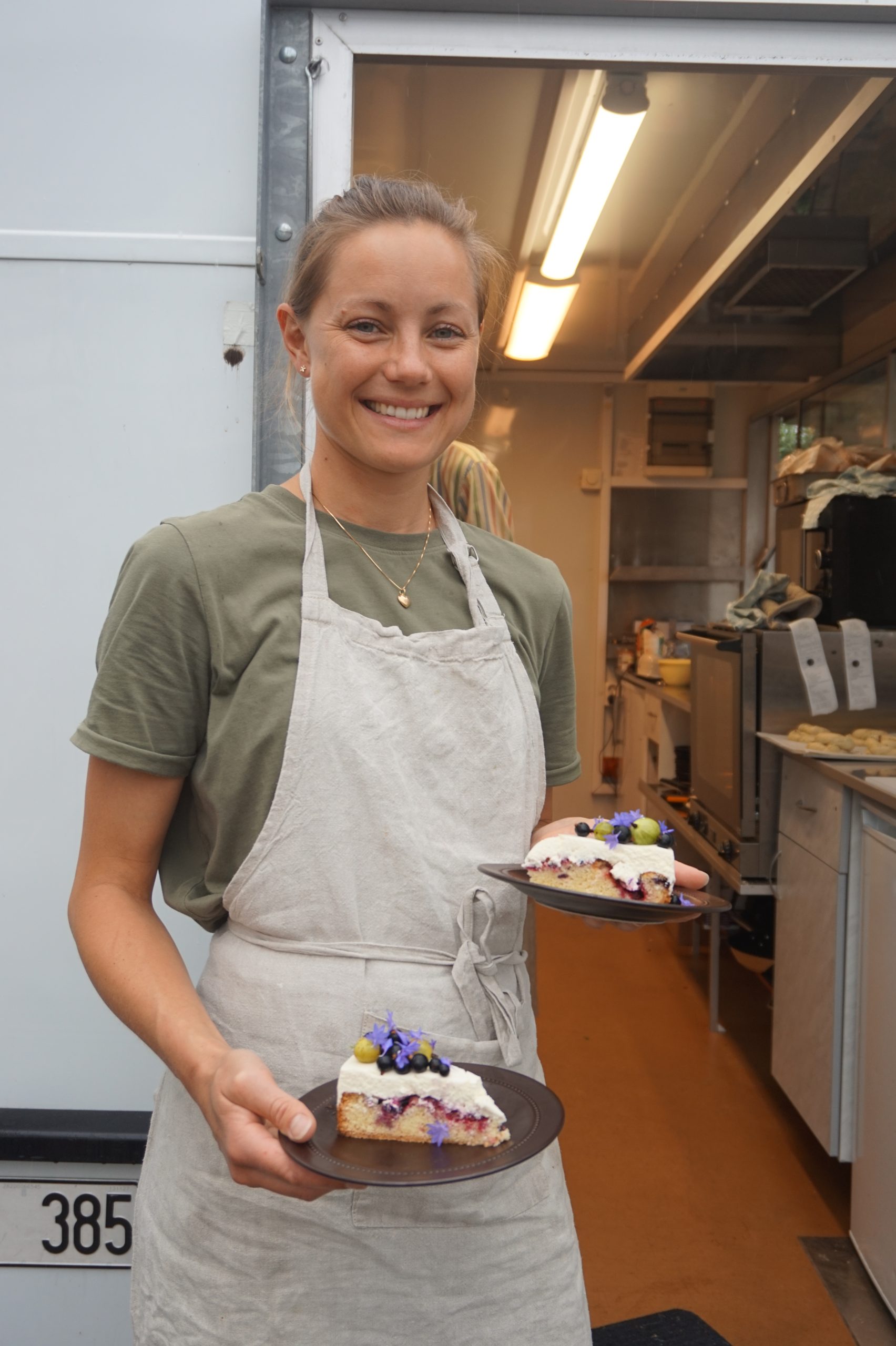 Woman serving cake in kitchen